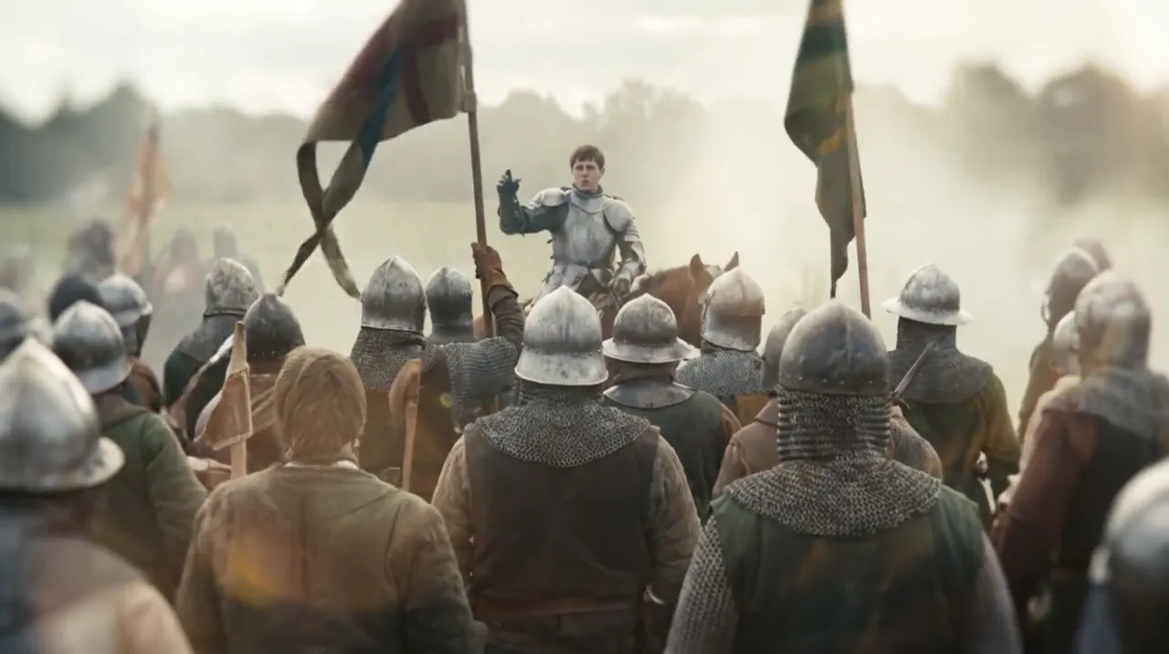 Helmeted medieval soldiers with banners seen from behind, facing a mounted knight