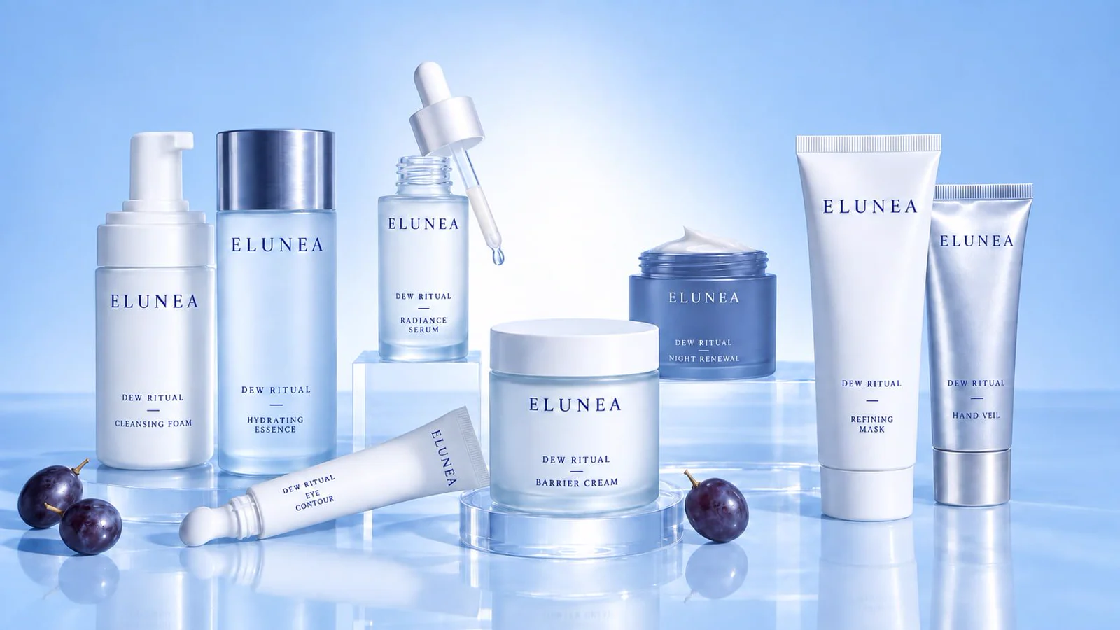 White and blue skincare bottles, jars and tubes arranged on glass blocks against a pale blue background